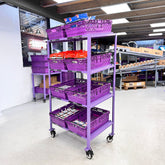 A purple MegaMaxx PRO 600mm x 400mm Bale Arm Crate Storage Trolley Shelving Unit with four tiers, on castor wheels, filled with purple crates.